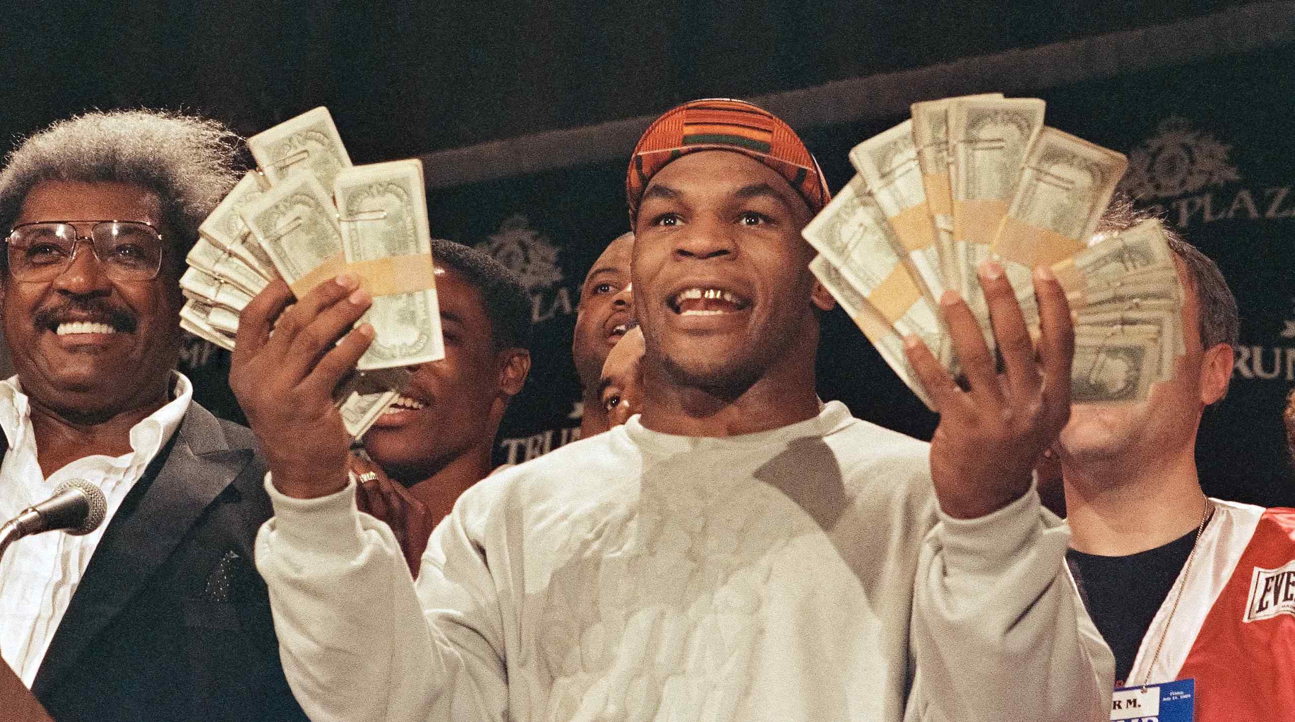 Mike Tyson fanning out dollar bills
